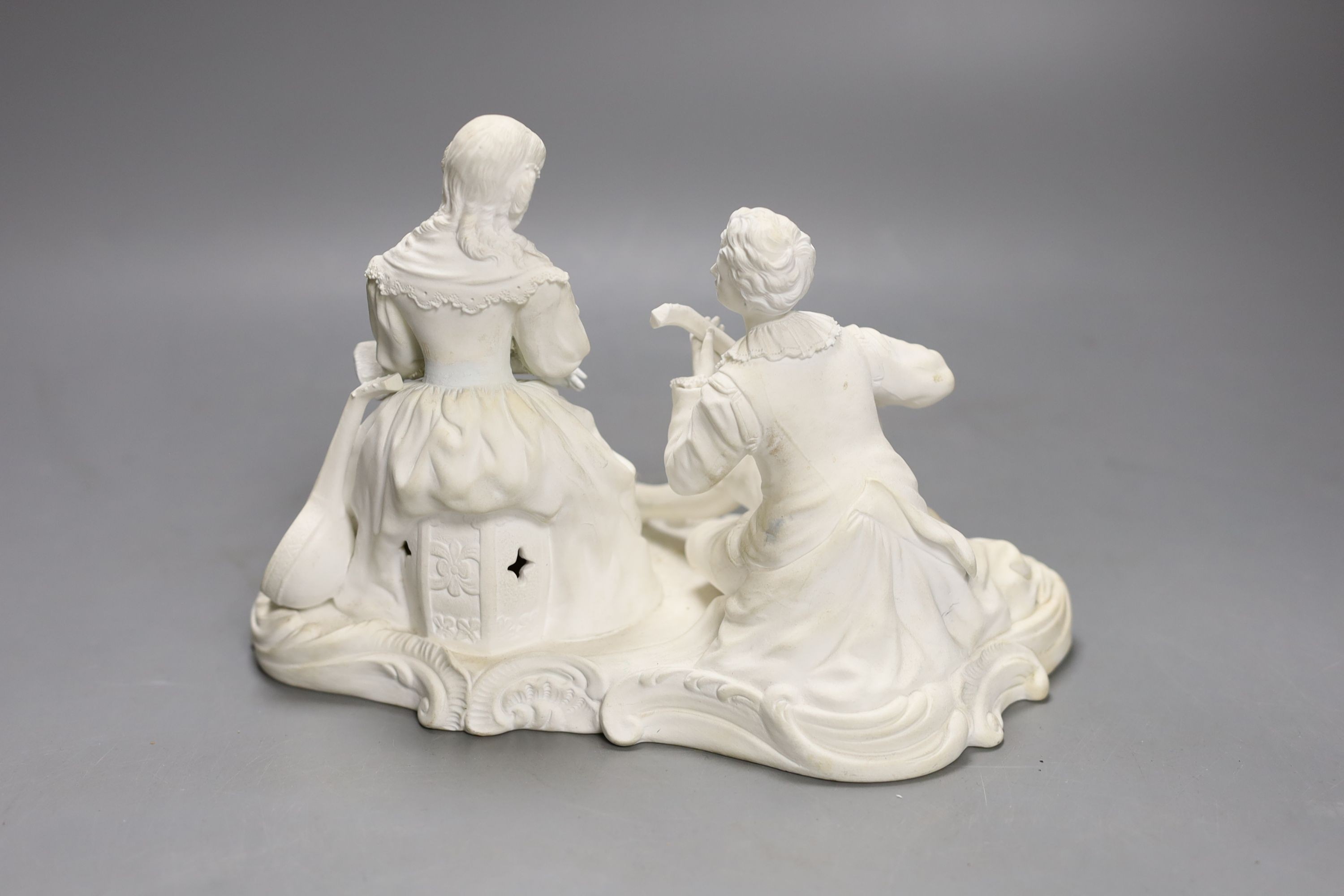 A 19th century Minton biscuit group of a boy with a lute and a girl with a fan, 22cm wide